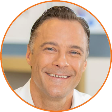 Professional headshot of a smiling food industry executive wearing white business attire for B2B foodservice networking.