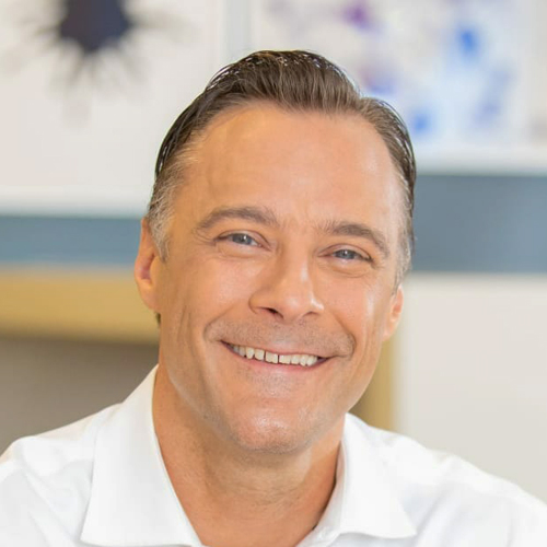 Professional headshot of food industry executive in white shirt, ideal for B2B food supply and distribution company leadership profiles.